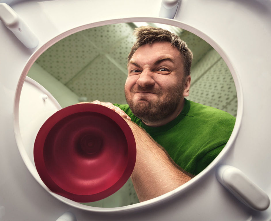 A man coming toward a toilet with a plunger from the toilet's point of view